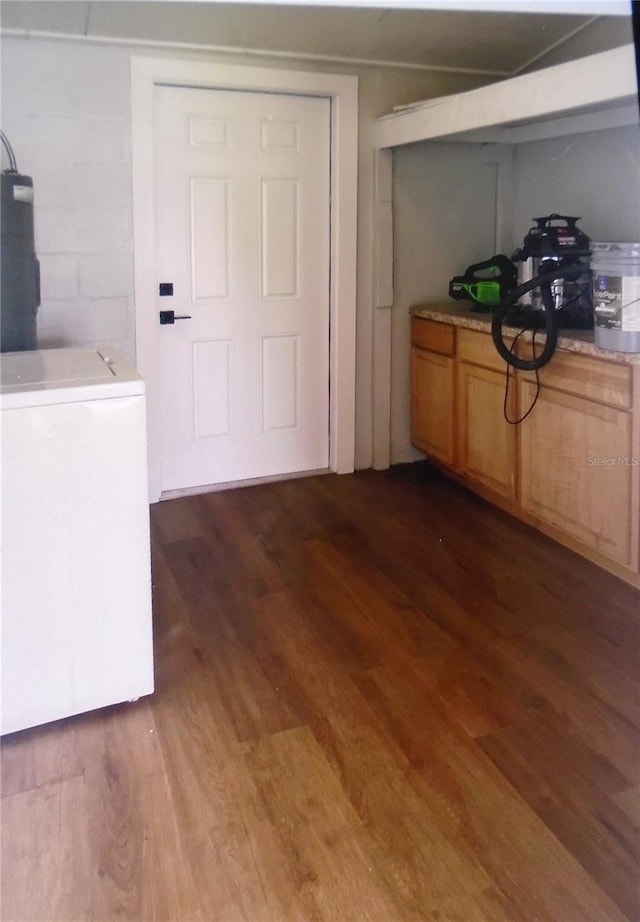 interior space with dark wood-type flooring and washer / dryer