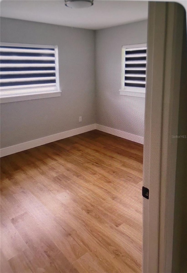 empty room with light hardwood / wood-style flooring