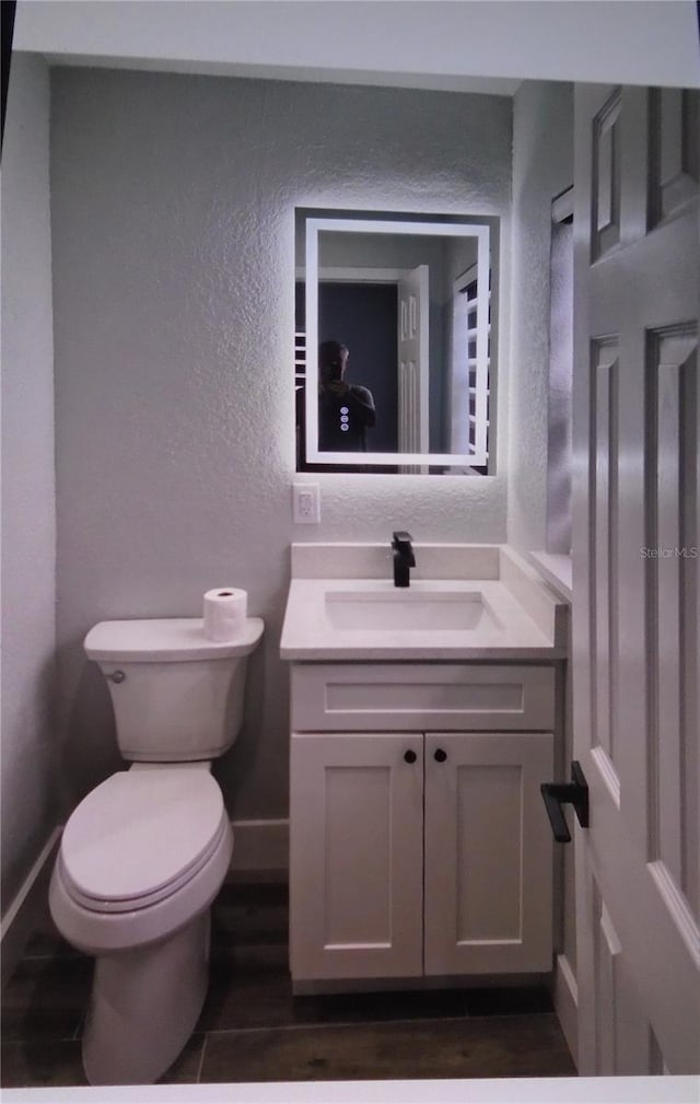 bathroom featuring vanity and toilet