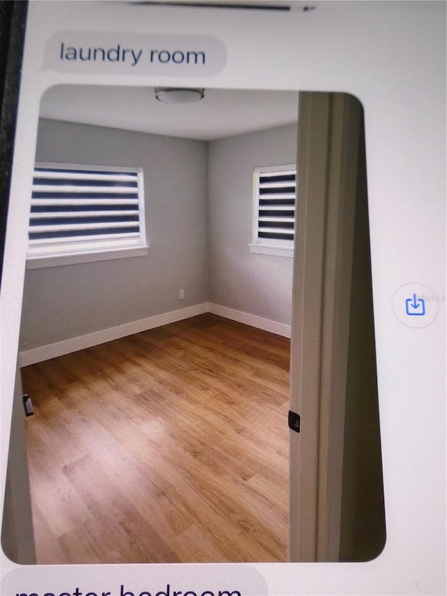 empty room with hardwood / wood-style floors