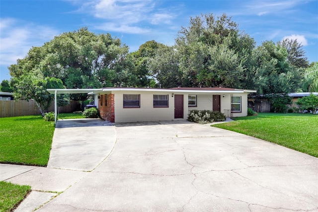 single story home featuring a carport and a front lawn