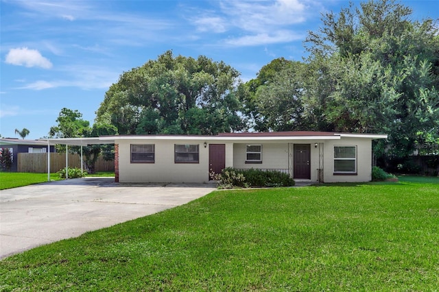 single story home featuring a front yard and a carport