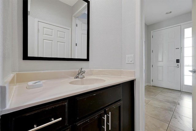 bathroom with tile patterned flooring and vanity