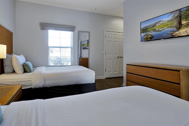 bedroom with a closet and dark hardwood / wood-style floors