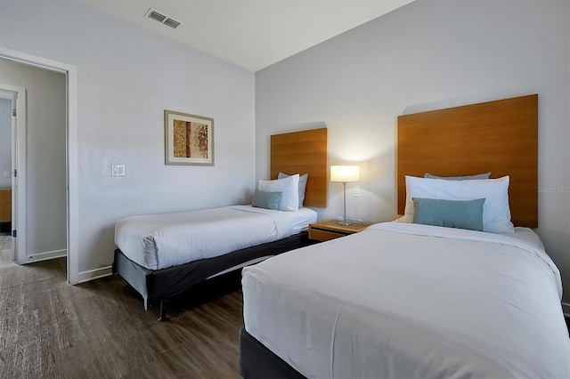 bedroom with dark hardwood / wood-style floors