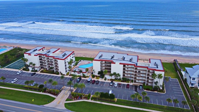 bird's eye view featuring a water view and a beach view