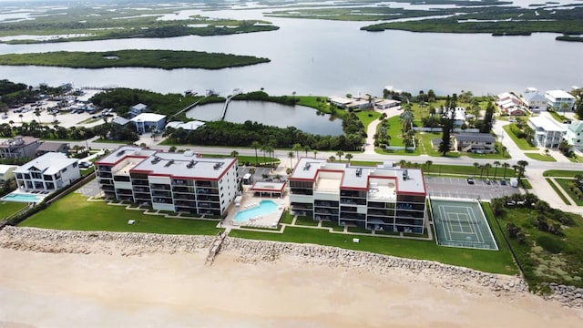 bird's eye view with a water view and a beach view