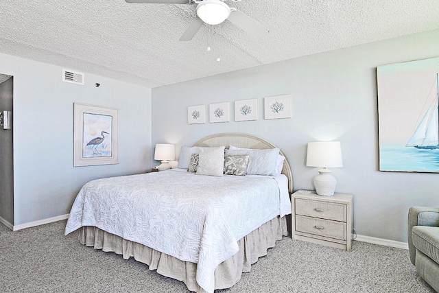 carpeted bedroom featuring baseboards, visible vents, ceiling fan, and a textured ceiling