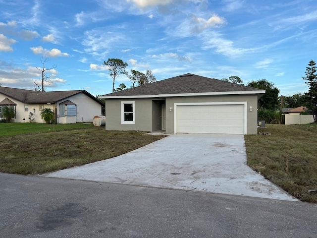 single story home featuring a front yard and a garage