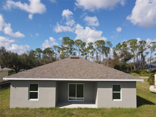 1378 Wilmette St, Port Charlotte, FL 33980 - rear view of house featuring roof with shingles, stucco siding, a lawn, and a patio area