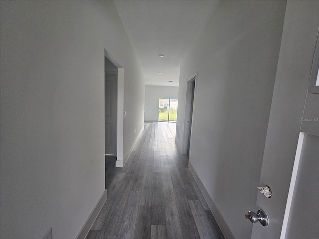 hallway with dark hardwood / wood-style floors