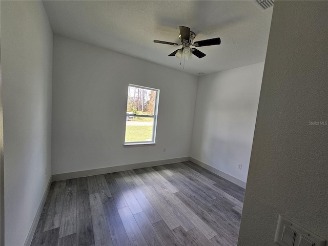 spare room with ceiling fan, a textured ceiling, and light hardwood / wood-style flooring