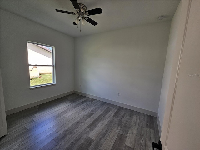 spare room with ceiling fan and dark hardwood / wood-style floors