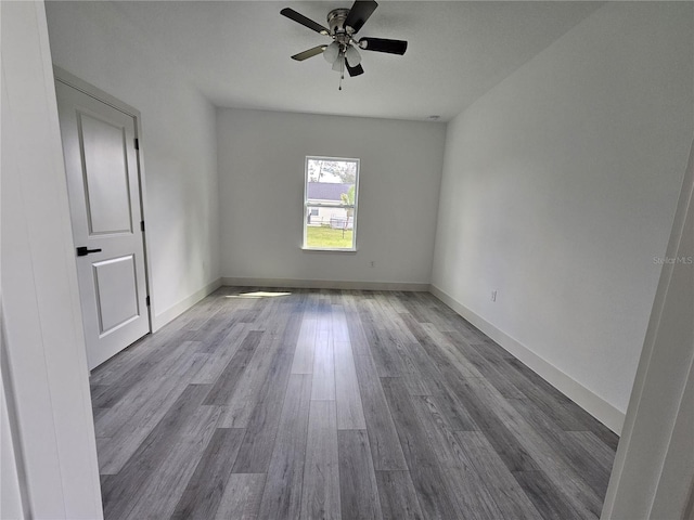 spare room with light hardwood / wood-style flooring and ceiling fan