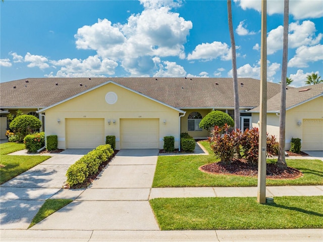 ranch-style house featuring a garage and a front yard