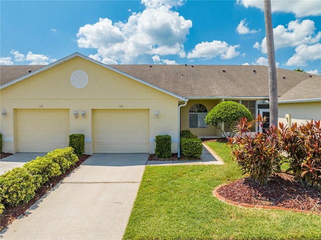 ranch-style house with a garage and a front lawn