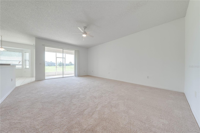 carpeted empty room with a textured ceiling and ceiling fan