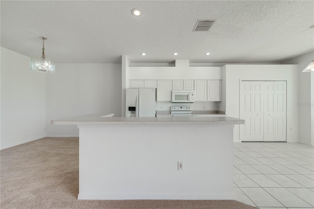 kitchen featuring pendant lighting, white appliances, a spacious island, white cabinetry, and light carpet