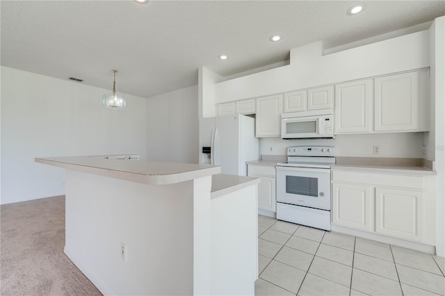 kitchen with light colored carpet, decorative light fixtures, white cabinets, and white appliances