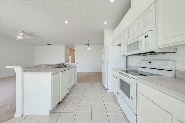 kitchen featuring white cabinetry, white appliances, kitchen peninsula, ceiling fan, and sink