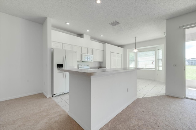 kitchen featuring white cabinets, pendant lighting, white appliances, a textured ceiling, and light carpet