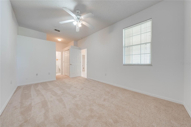 interior space with ceiling fan and light carpet