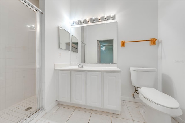 bathroom featuring vanity, tile patterned flooring, toilet, and an enclosed shower