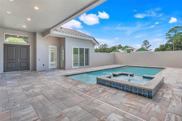 view of pool with a patio and an in ground hot tub