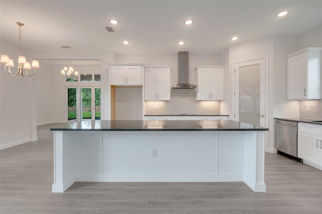 kitchen featuring white cabinetry, tasteful backsplash, wall chimney exhaust hood, dishwasher, and pendant lighting