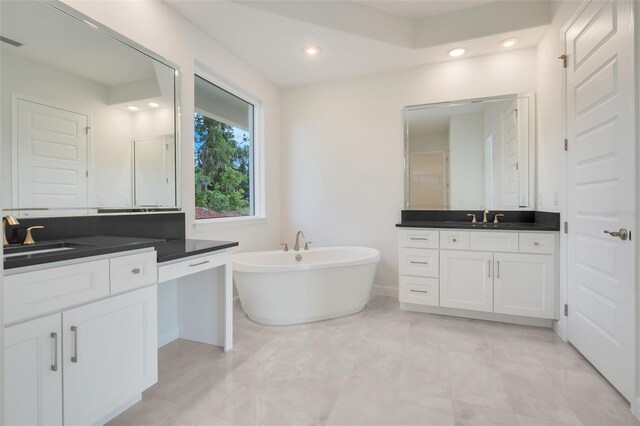 bathroom featuring vanity and a bathing tub