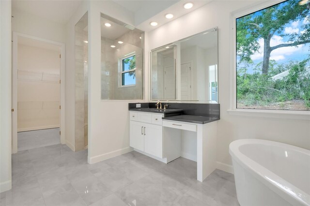 bathroom with vanity and a tub