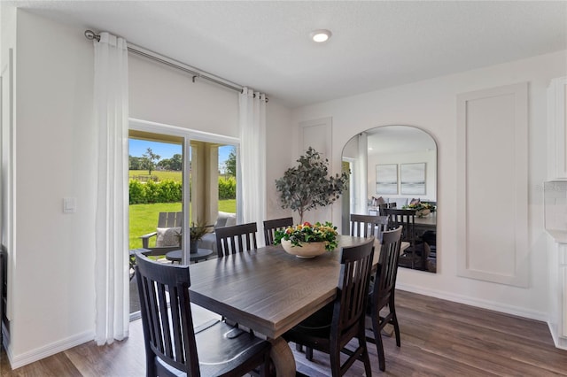 dining area featuring a textured ceiling and dark wood-type flooring