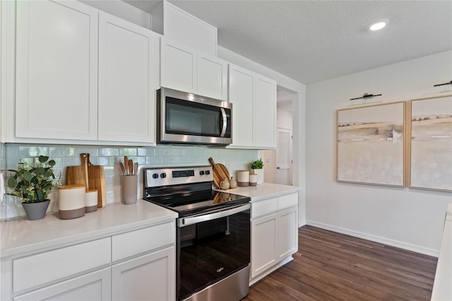 kitchen with tasteful backsplash, a textured ceiling, white cabinetry, stainless steel appliances, and dark hardwood / wood-style flooring