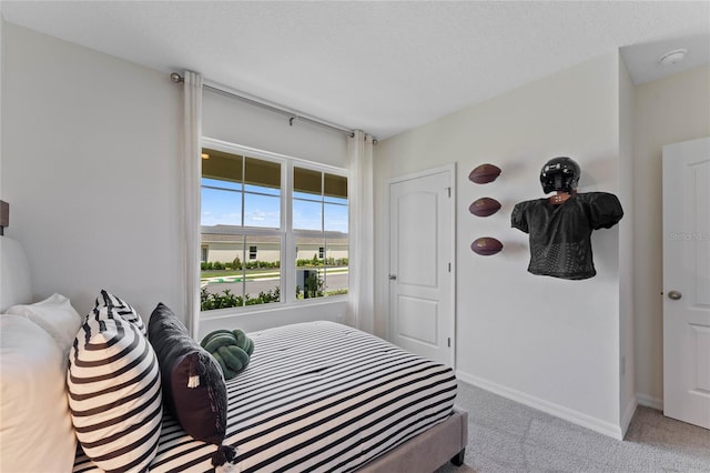 carpeted bedroom with a textured ceiling