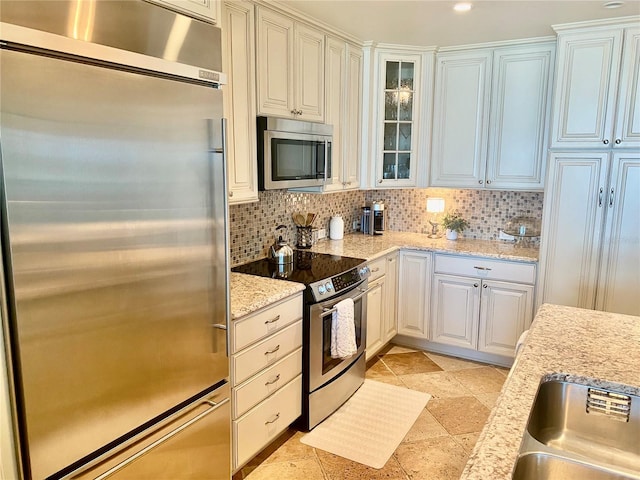 kitchen with white cabinetry, appliances with stainless steel finishes, and tasteful backsplash