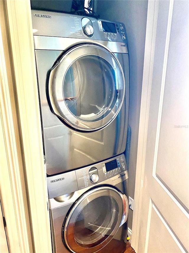 laundry room with stacked washer / dryer