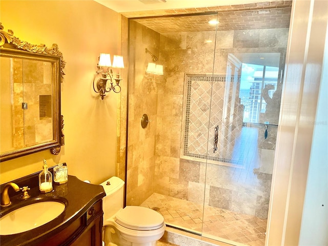 bathroom featuring walk in shower, vanity, and toilet