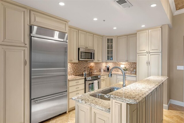 155 S Court Ave Unit 2710, Orlando, FL 32801 - kitchen featuring cream cabinets, stainless steel appliances, a sink, baseboards, and recessed lighting