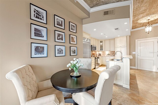 155 S Court Ave Unit 2710, Orlando, FL 32801 - dining space featuring ornamental molding, baseboards, and recessed lighting