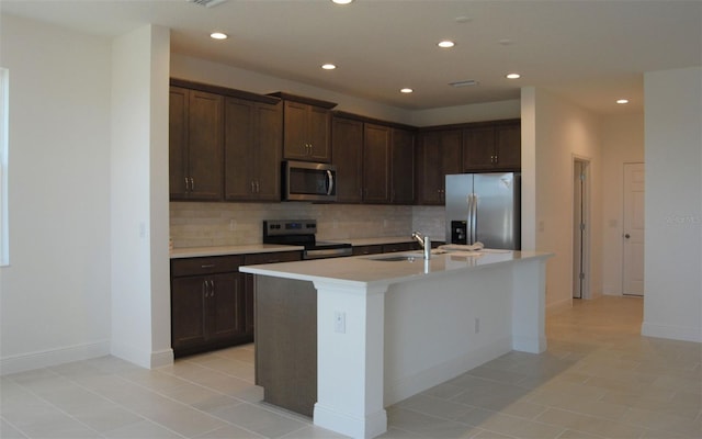 14569 Crestavista Dr, Clermont, FL 34714 - kitchen featuring appliances with stainless steel finishes, decorative backsplash, dark brown cabinetry, light countertops, and recessed lighting