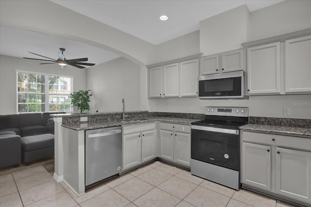 kitchen with stainless steel appliances, ceiling fan, and light tile patterned floors