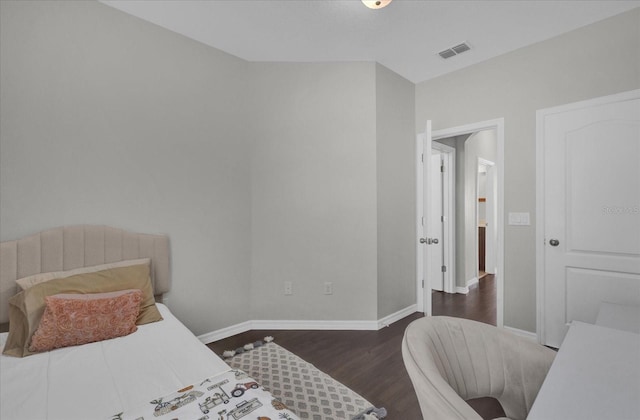 bedroom with dark hardwood / wood-style flooring