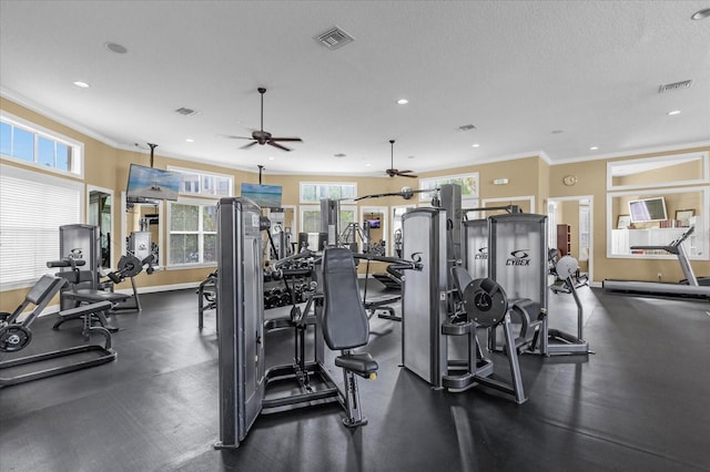 workout area featuring a textured ceiling, crown molding, and ceiling fan