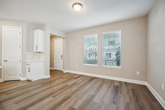 spare room with light hardwood / wood-style flooring