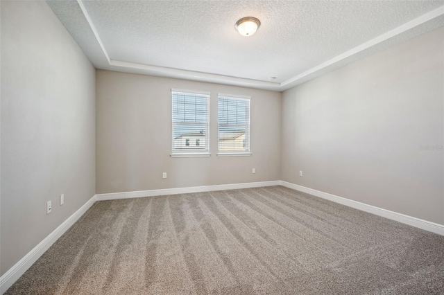 carpeted empty room featuring a textured ceiling