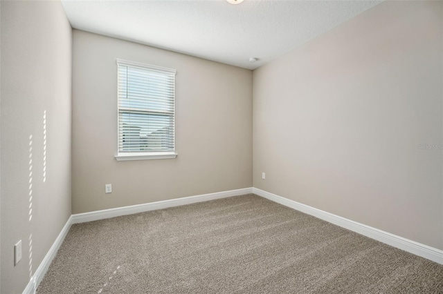 carpeted empty room with a textured ceiling