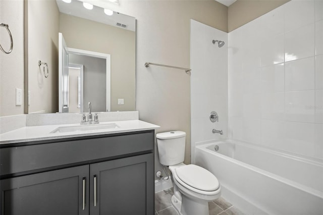 full bathroom with tiled shower / bath, tile patterned flooring, vanity, and toilet