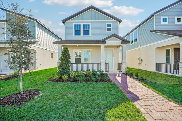 11944 Bracco St, Winter Garden, FL 34787 - craftsman-style house with covered porch and a front yard