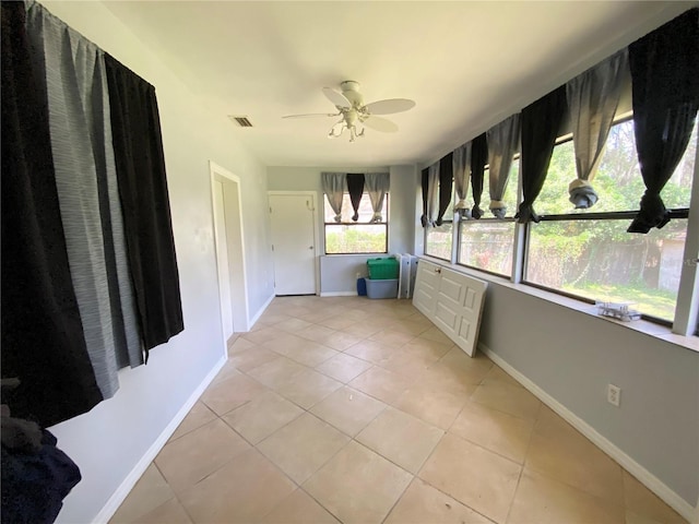 interior space with ceiling fan