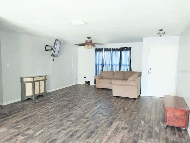 living room featuring dark wood-type flooring and ceiling fan